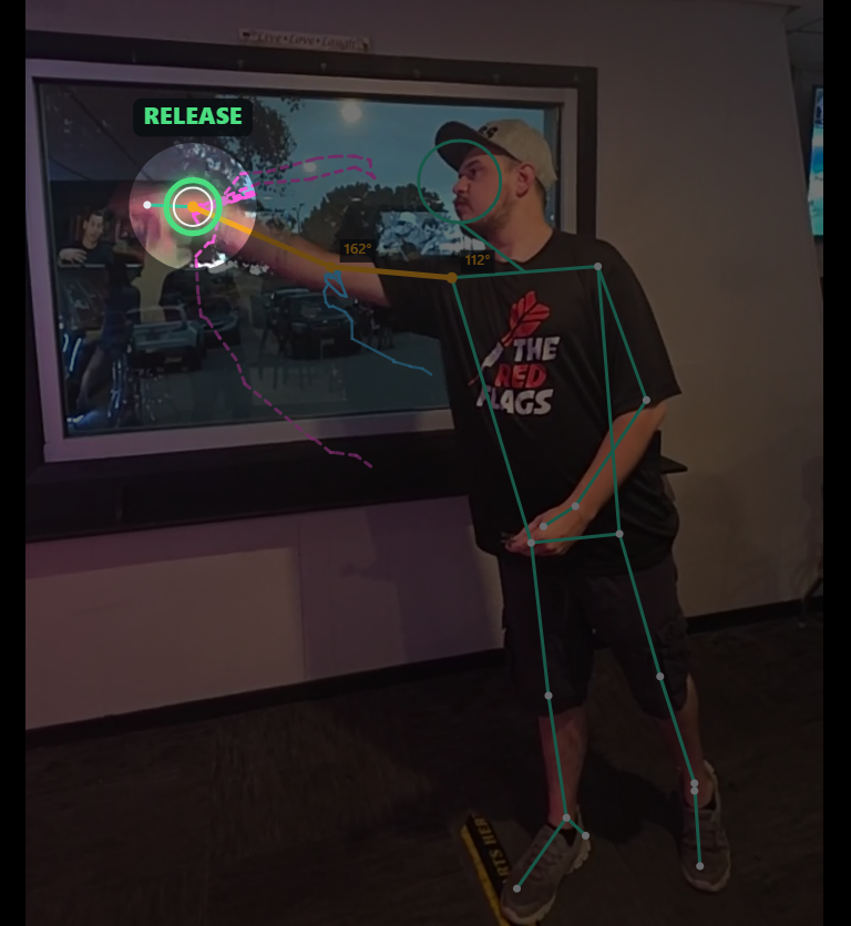 The release frame: the video dims except a spotlight on the throwing hand, ringed in green with a RELEASE badge.